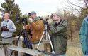 This group of birders wait for locks of birds on the high dune staircase platform called the Green Tower site in the west lot at Indiana Dunes State Park.  From left are Brendan Grube, John Cassady, Randy Pals and Ken Brock.