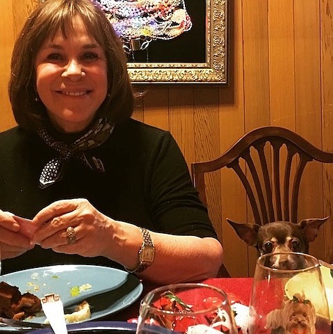 Diana Couture, author of "The ongoing life-affirming adventures of Rose and Dawn" at one of her family's traditional Italian dinners... note the hopeful chihuahua.