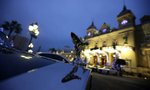A luxury car is parked on Monte Carlo Casino square in Monaco, which is lit for holiday season, December 7, 2010. REUTERS/Eric Gaillard