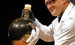 A chemist is reflected in a beaker after mixing chemicals that gave the beaker a reflective coating during a demonstration at the 21st annual Ig Nobel prize ceremony at Harvard University in Cambridge, Massachusetts September 29, 2011. REUTERS/Adam Hunger