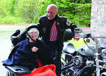 Smiling resident Jackie Palmquist posing with a Harley Davidson at Providence Marianwood’s Harley Days event. Photo courtesy Providence Marianwood.