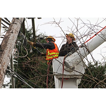 Seattle City Light Lineworker Pavle Trifunovic uses a hot stick to help repair power lines damaged by an ice storm. Photo courtesy Seattle City Light