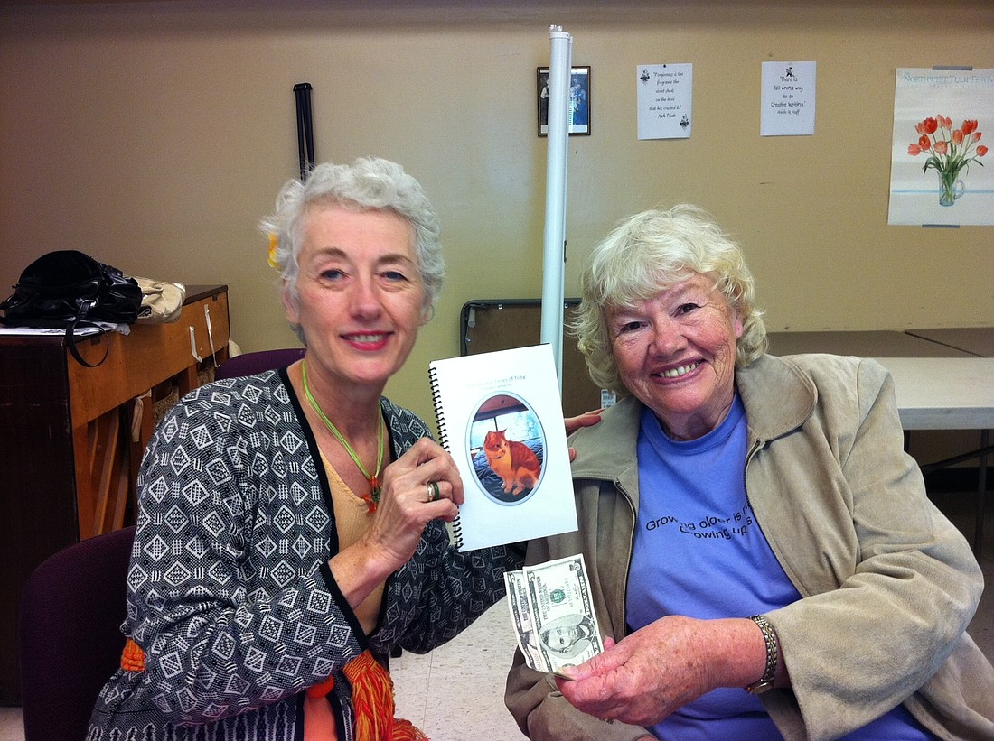 Ariele and Connie Campbell with her book The Life and Times of Toby: the big ol’ yellow cat--the story of the cat that had adopted her church. 