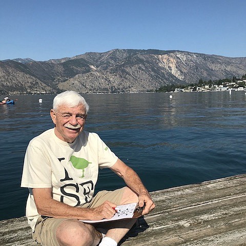 Northwest Prime Time's puzzlemaster, Len Elliott, working a crossword while on vacation at Wapato Point on Lake Chelan. Photo credit to LisaRuth Elliott.