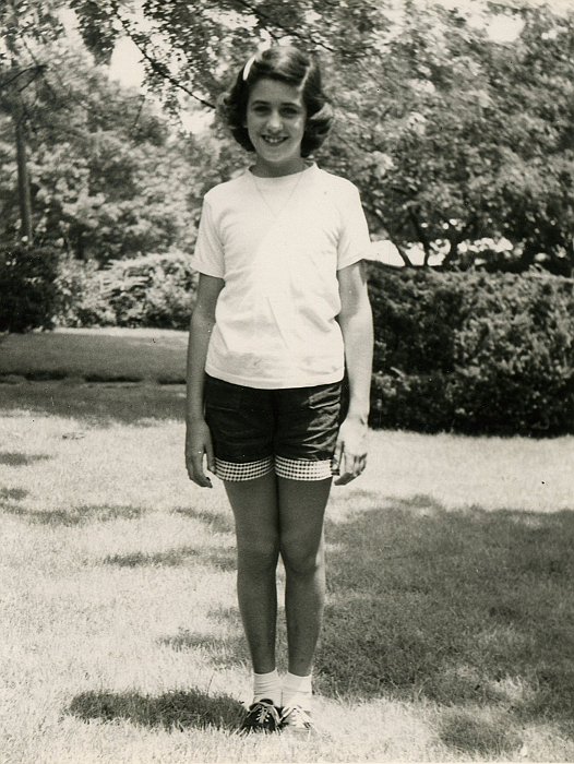Suzanne in the front yard of her childhood home on Staten Island