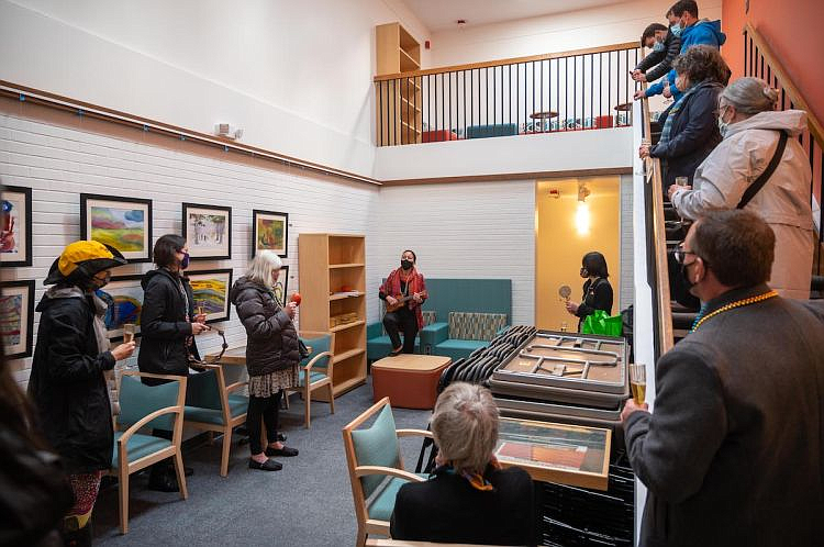 A group celebrates the completion of the Memory Hub renovations