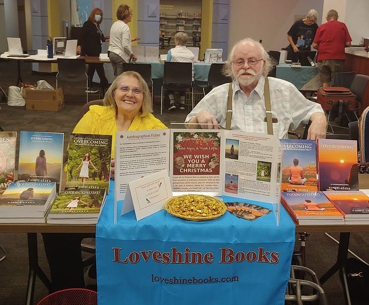 Noah LeVia and his wife Vashti with their books