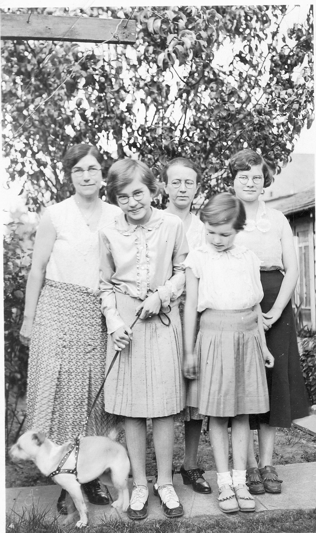 At about the same time as the star poem, a photo of me holding Micky’s leash.
From left to right, my aunt Aun, Patricia Davis, my mother Pearl, sister Dorothy next to me, and sister Frances behind her.