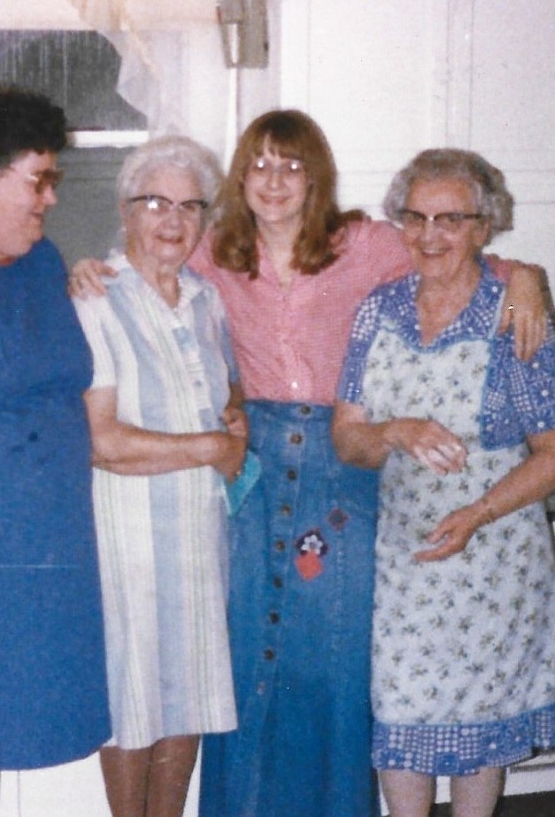 The author, Marilyn Michael (center right) with her grandmother, Ruth Allen (far right), her grandmother's sister, Mame (center left), and a cousin (far left). Marilyn says: "We are standing in my grandma's kitchen and behind my grandma is an original Hoosier kitchen cabinet unit (popular in the 1920s)."