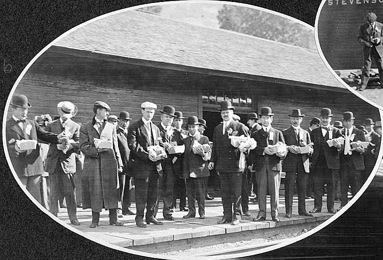 Excursion members holding fruit baskets at the Stevenson train station, 1908. Stevenson was named for the Stevenson family, who purchased the town in 1893. By the early 1900s, Stevenson was a thriving location with saloons, shops, hotels, and a booming logging industry.