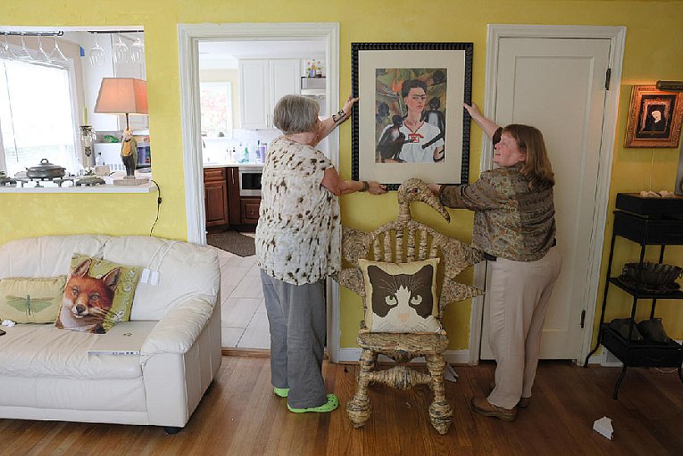 Maryann Griffin and Sandra Mears discuss where to hang a print of Frida Kahlo’s “Self-Portrait with Monkeys” in their new home, May 29, 2024. (Genna Martin/Cascade PBS)