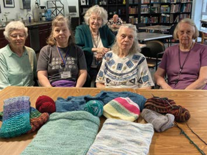 Some of the Northhaven Handcrafters pose with their gifts. Photo by Gwen Campbell, courtesy RSVP program through Solid Ground.