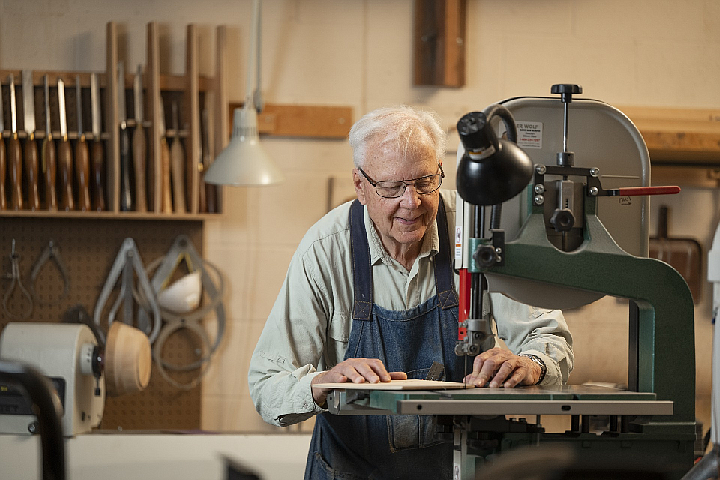 Emerald Heights residents in Redmond made 500 wooden toys by hand to donate to local charities. Toys included ducks, airplanes, trucks, trains, buses, boats and more. This resident is working in the onsite woodworking shop.