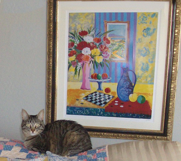 Nina the cat with ‘shared’ art in background